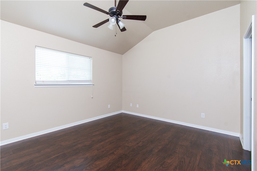 1102 Grace Point Drive, Unit A Killeen, TX 76549 - Photo 14 of 18 an empty room with wooden floor fan and windows