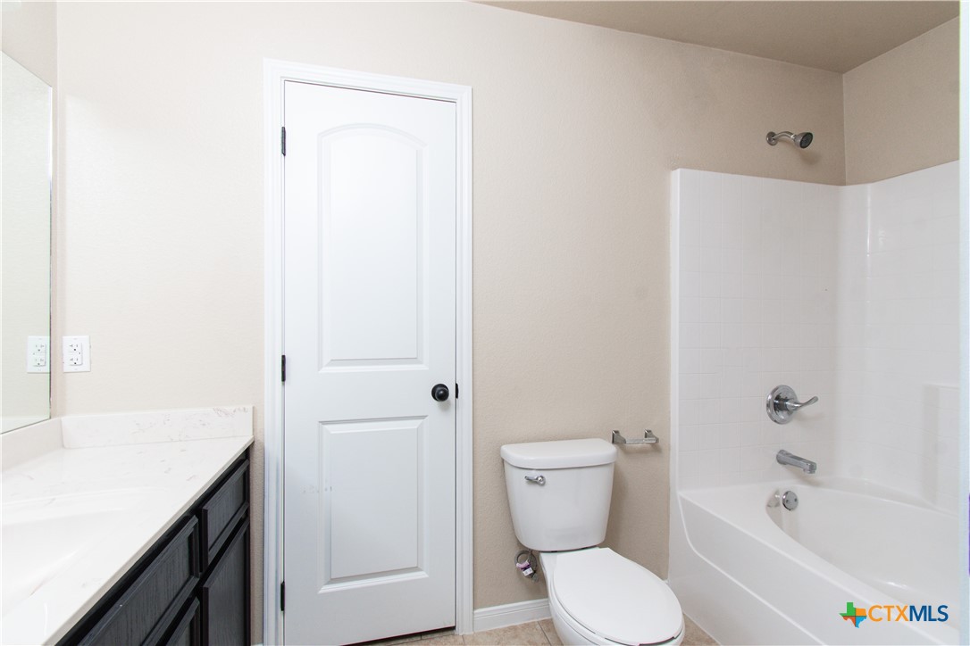 1102 Grace Point Drive, Unit A Killeen, TX 76549 - Photo 17 of 18 a bathroom with a sink a toilet and shower