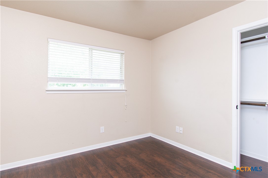 1102 Grace Point Drive, Unit A Killeen, TX 76549 - Photo 7 of 18 a view of a small space with wooden floor and a window