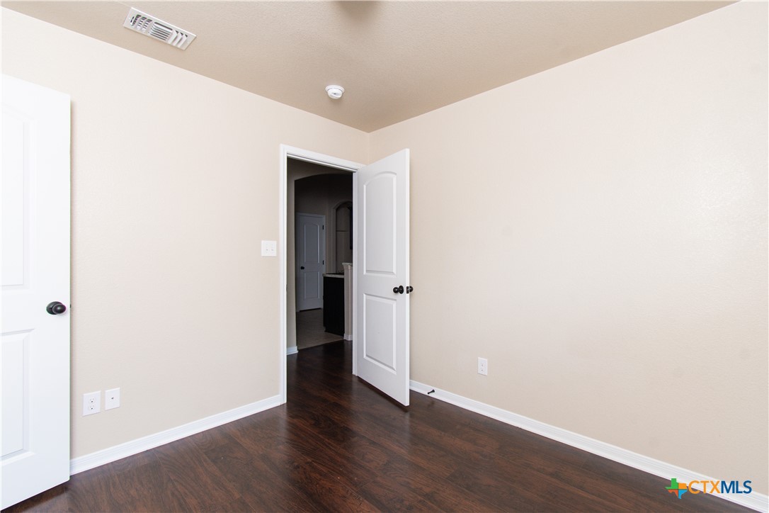 1102 Grace Point Drive, Unit A Killeen, TX 76549 - Photo 9 of 18 a view of an empty room with wooden floor