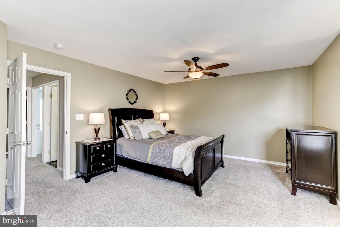 10106 Sir Reynard Lane Bristow, VA 20136 - Photo 13 of 28 a bed room with a bed and a chandelier