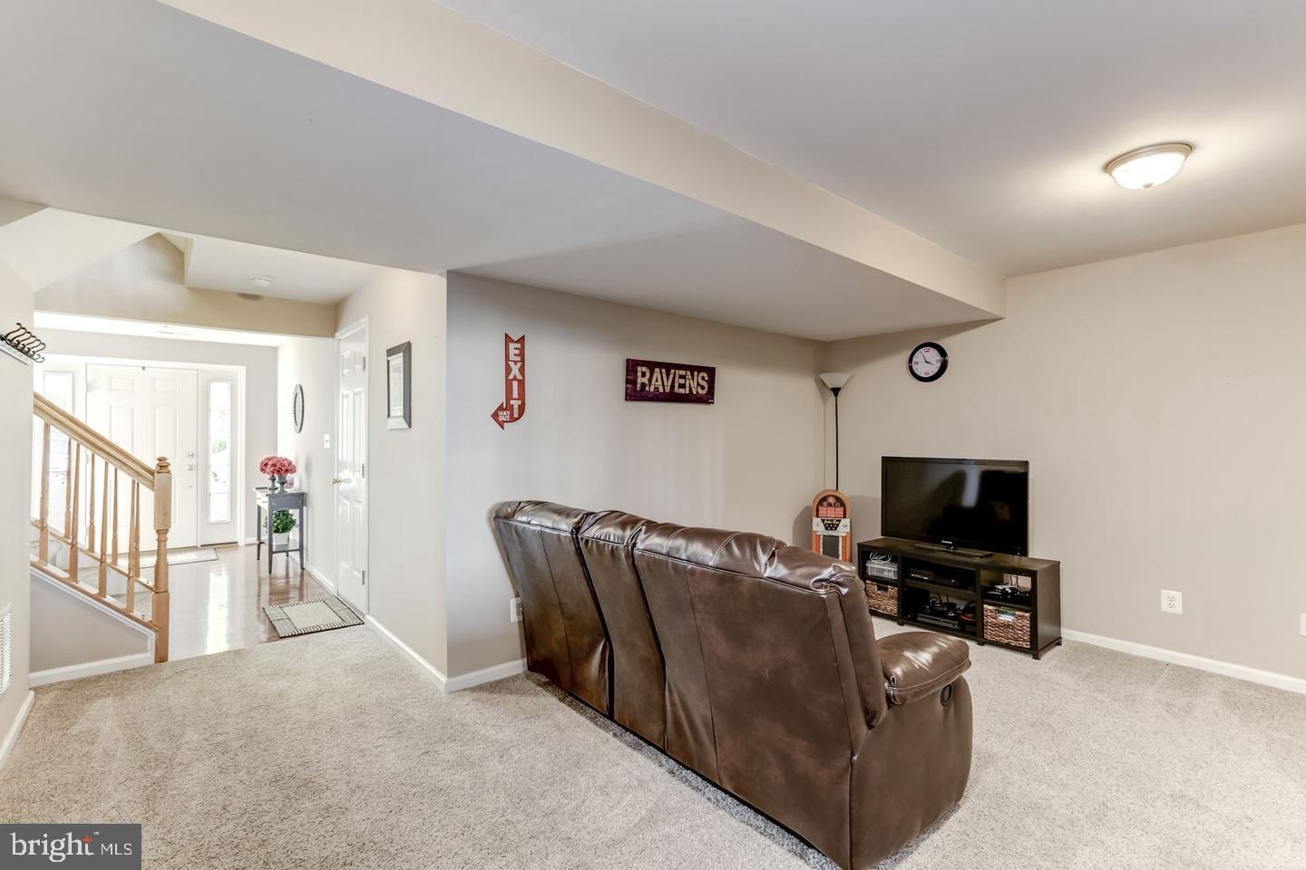 10106 Sir Reynard Lane Bristow, VA 20136 - Photo 19 of 28 a living room with furniture and a flat screen tv
