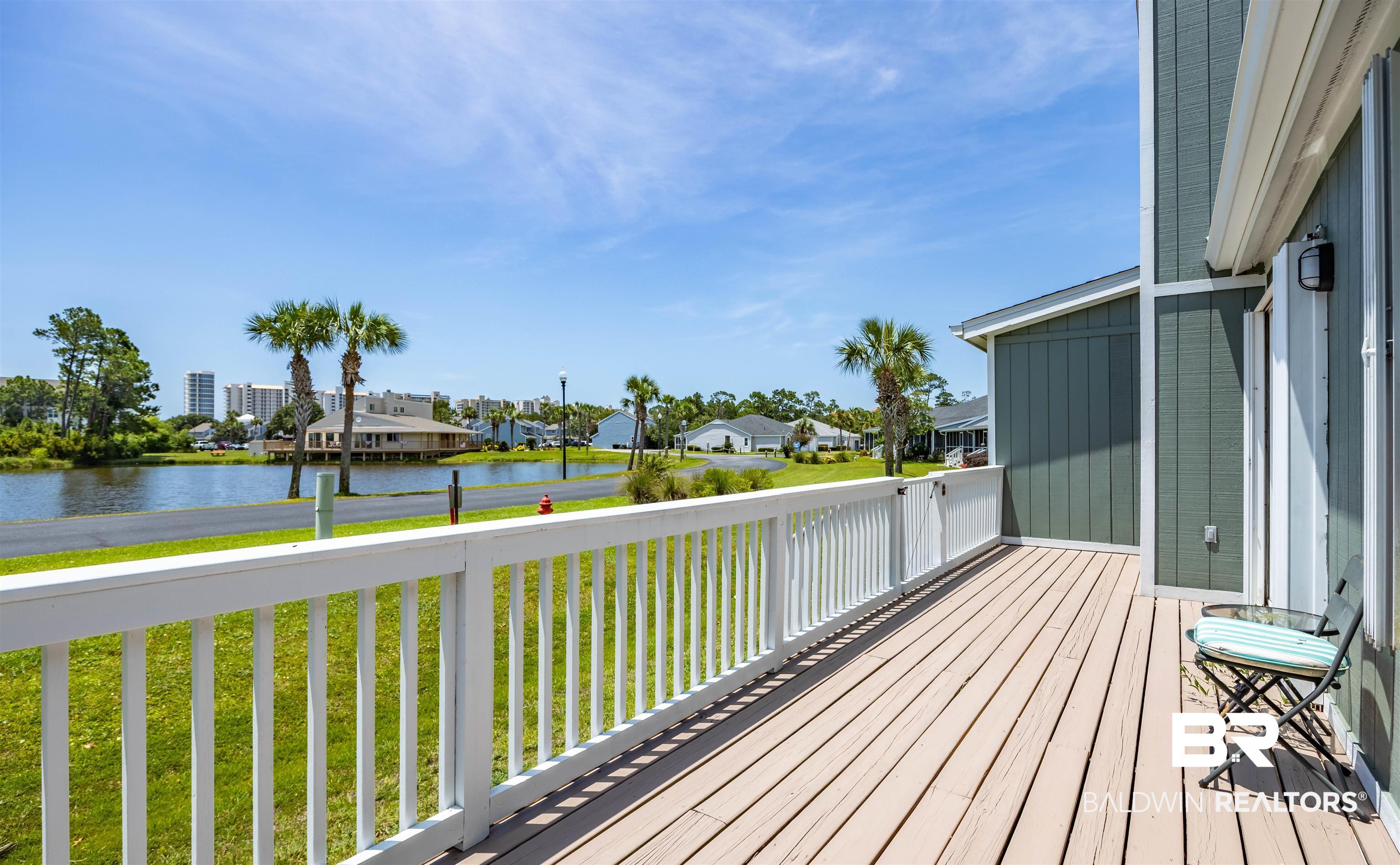 3200 Loop Road, Unit 96 Orange Beach, AL 36561 - Photo 5 of 49 Expansive outdoor deck with a white railing and composite decking, offering waterfront access