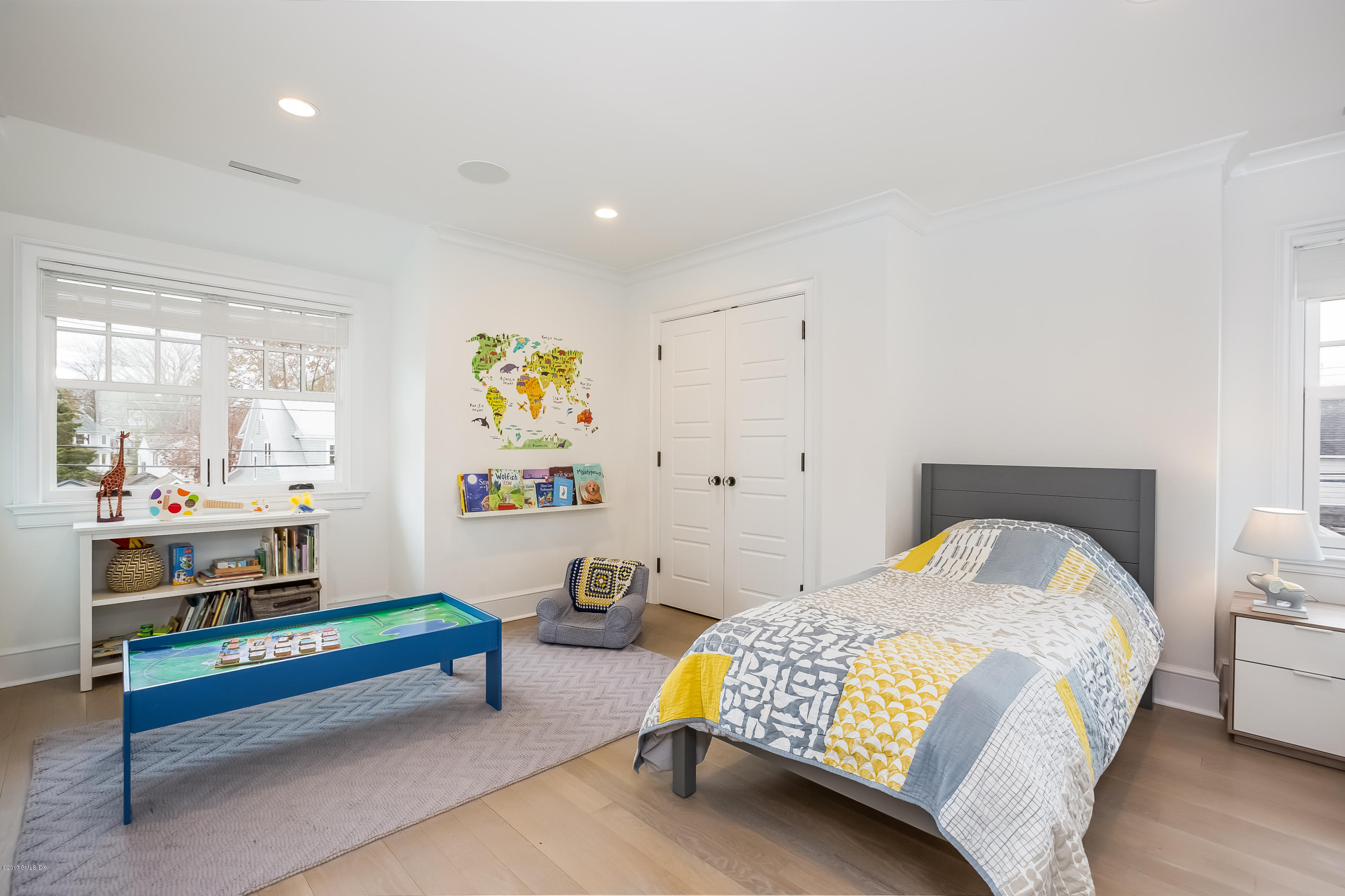 39 Edgewater Drive Old Greenwich, CT 06870 - Photo 11 of 19 a bedroom with a bed and paintings on the wall