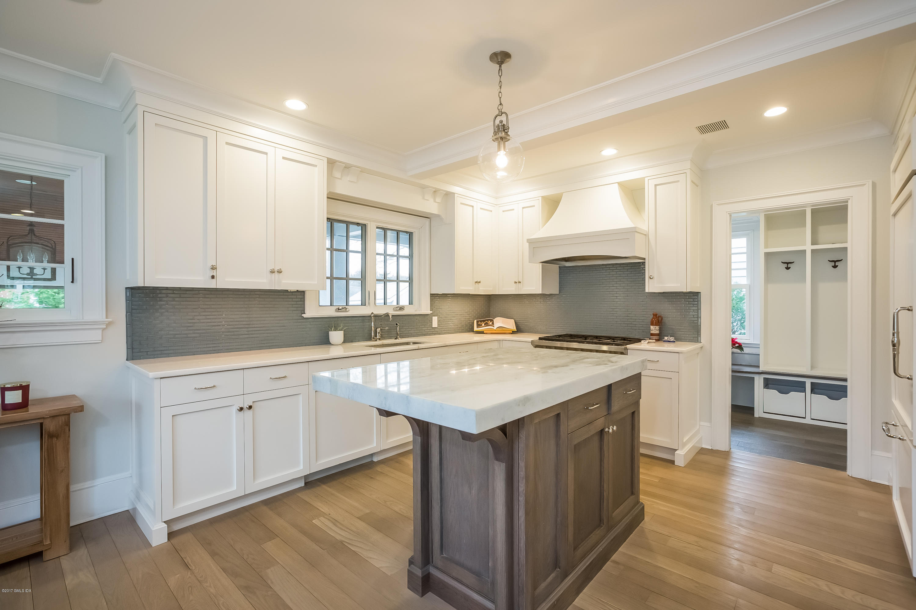 39 Edgewater Drive Old Greenwich, CT 06870 - Photo 5 of 19 a kitchen with a sink stove and wooden cabinets