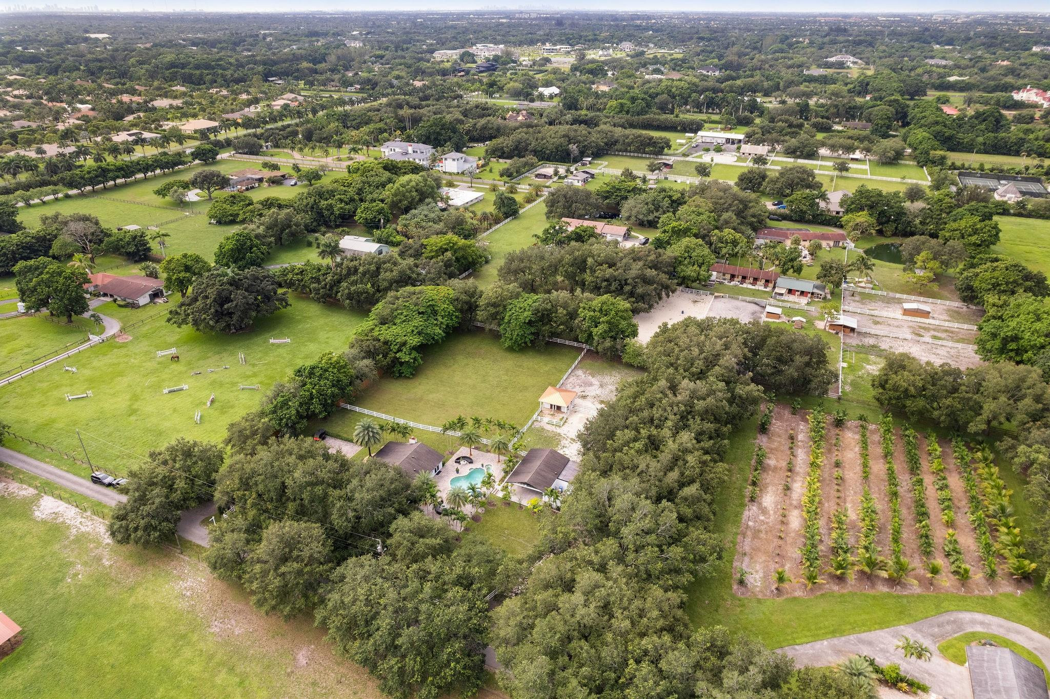 13800 Southwest 50th Manor Southwest Ranches, FL 33330 - Photo 54 of 73 an aerial view of residential houses with outdoor space and trees