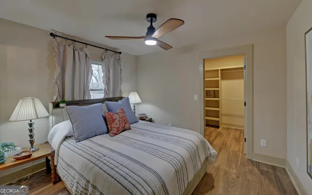 a bedroom with a bed and a night stand