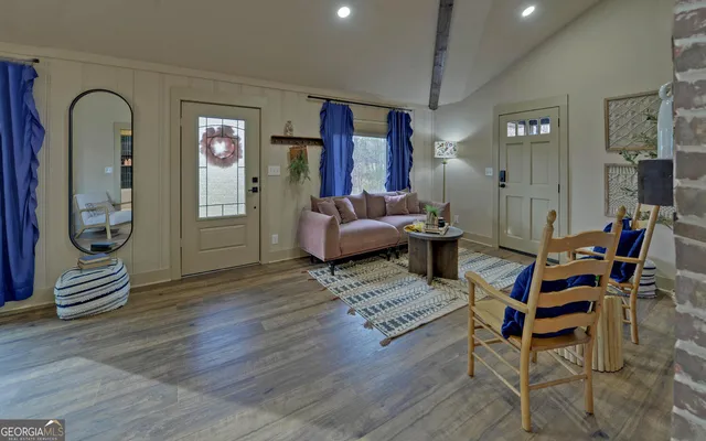 a living room with furniture and wooden floor