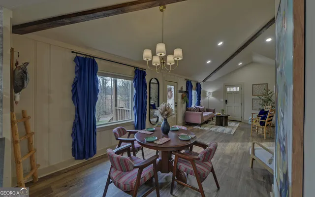 a view of a dining room with furniture and chandelier