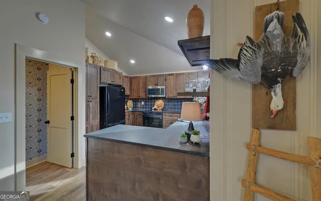 a kitchen with stainless steel appliances granite countertop a refrigerator and a stove top oven