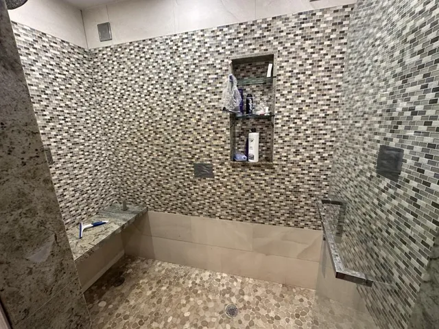 a bathroom with a shower and a bathtub