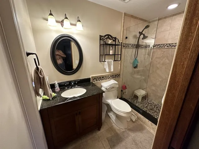 a bathroom with a toilet sink shower and mirror
