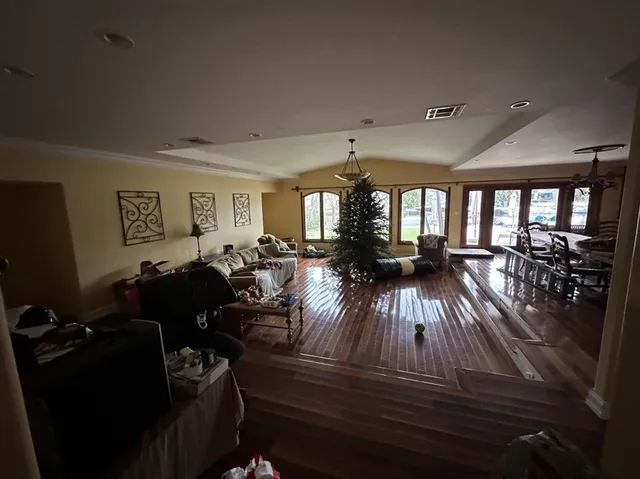 a living room with furniture and wooden floors