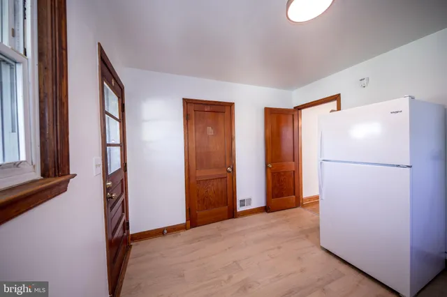 a view of an empty room with a refrigerator
