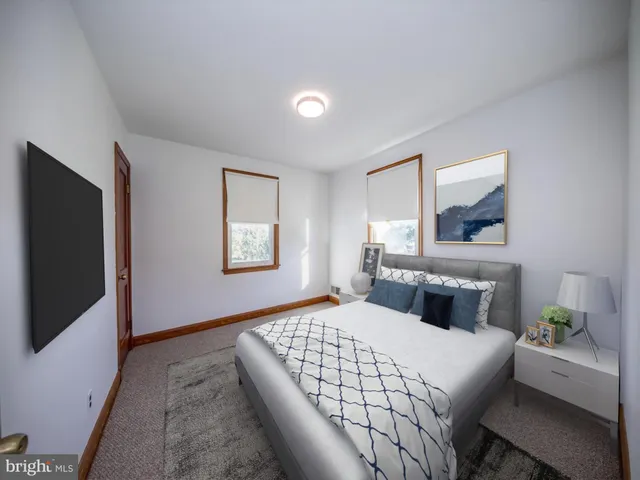 a bedroom with a large bed and a window