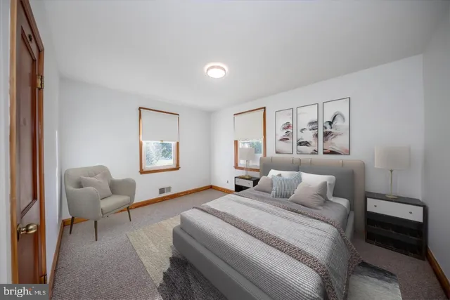 a bedroom with a bed and a couch