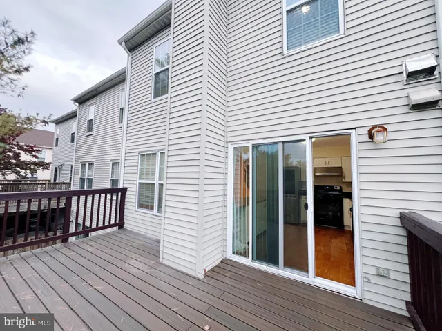 an empty room with wooden floor and fireplace