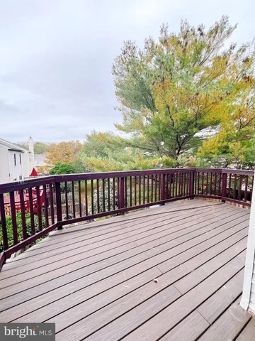 a view of kitchen with kitchen island wooden floor center island and stainless steel appliances