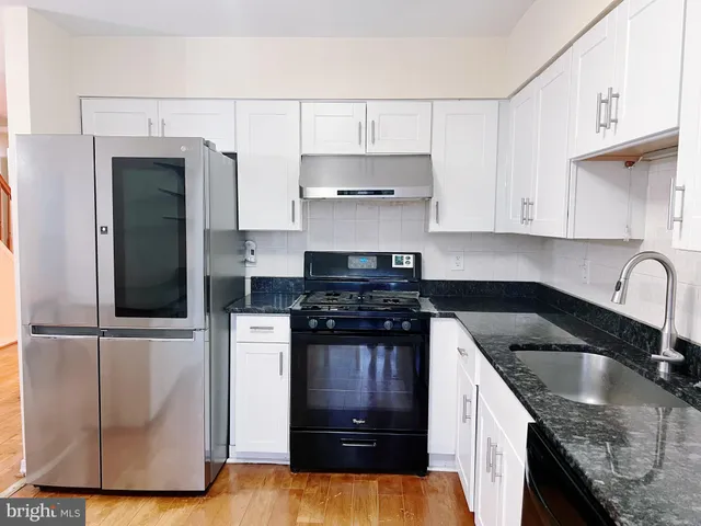 a kitchen with stainless steel appliances a refrigerator and a sink