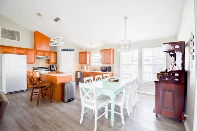 a dining room with furniture and wooden floor