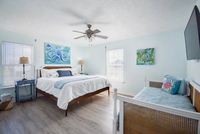 a bedroom with a large bed and a chandelier