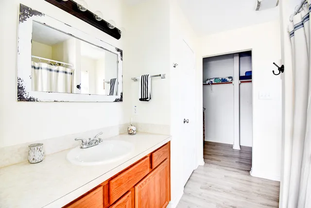 a bathroom with a sink a mirror and shower