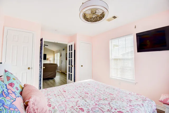 a bedroom with a bed and a window