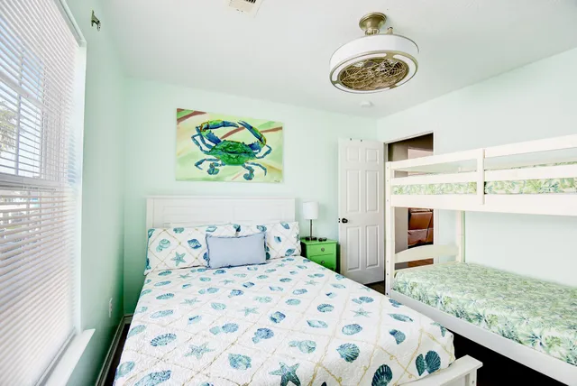 a bedroom with a bed and a large window