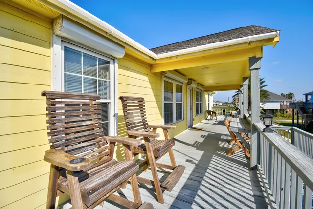 a view of a patio with table and chairs with wooden floor and plants