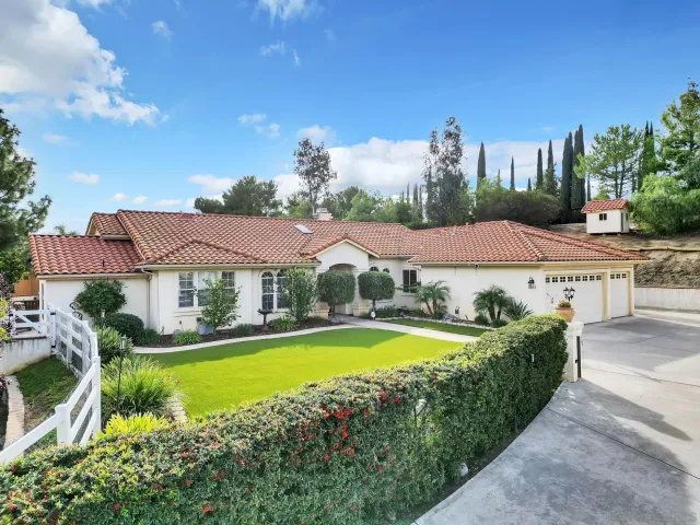 a view of a house with swimming pool and a yard