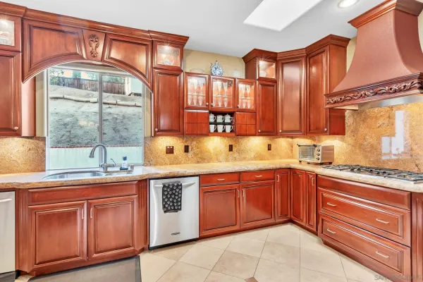 a spacious bathroom with a granite countertop sink a mirror and a bathtub