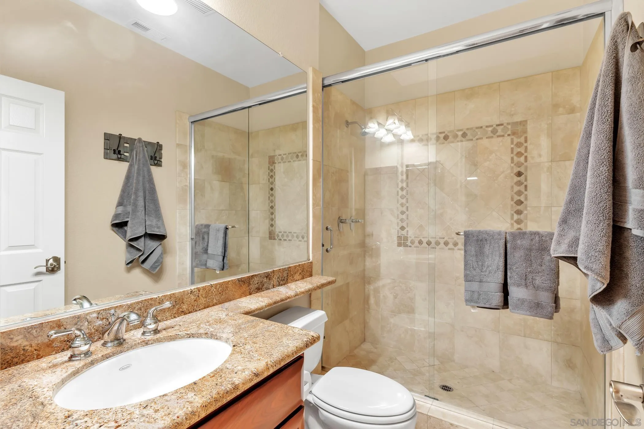 2389 Victoria Circle Alpine, CA 91901 - Photo 19 of 75 a bathroom with a granite countertop sink mirror toilet and shower