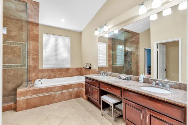 a bathroom with a shower and a bath tub