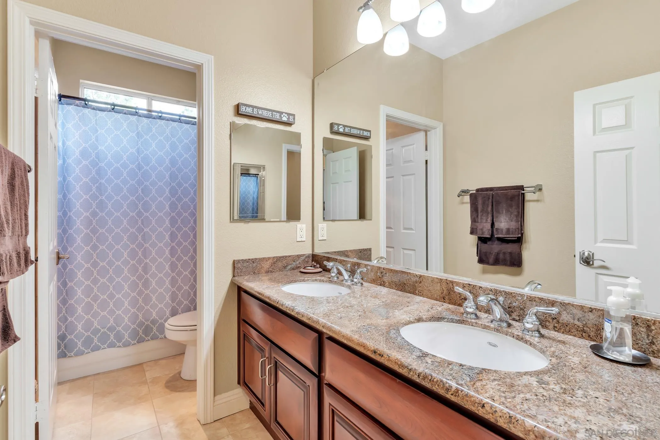 2389 Victoria Circle Alpine, CA 91901 - Photo 30 of 75 a bathroom with a granite countertop sink double vanity and a mirror