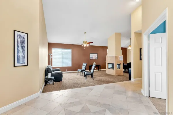 a living room with furniture a fireplace and a table