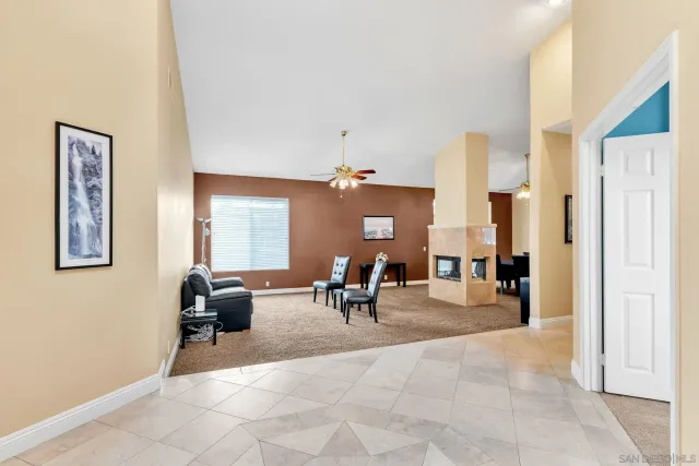 a living room with furniture a fireplace and a table