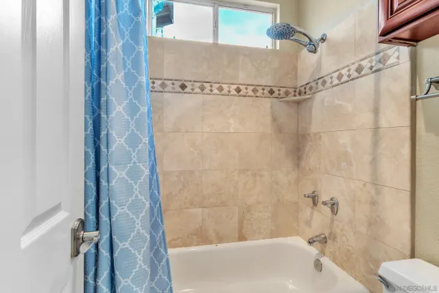 a view of living room with furniture and a chandelier