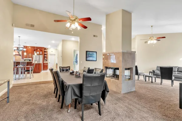 a kitchen with stainless steel appliances granite countertop a table and chairs