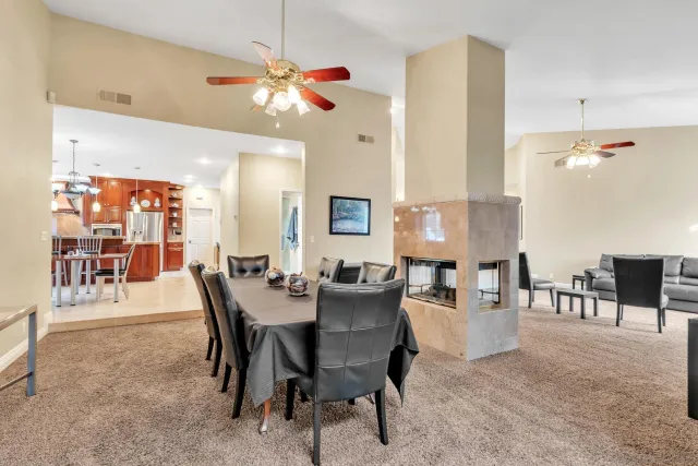 a kitchen with stainless steel appliances granite countertop a table and chairs