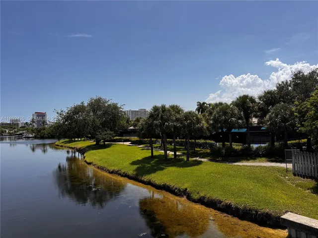 a view of a lake with houses in the back