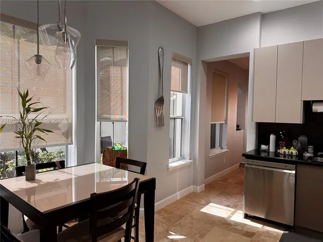 a kitchen with a table and chairs in it