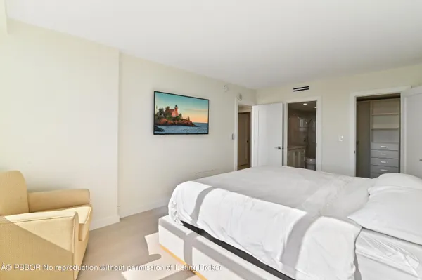 a bedroom with a bed and a couch
