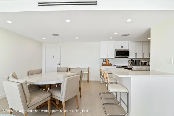 a view of kitchen with cabinets table and chairs