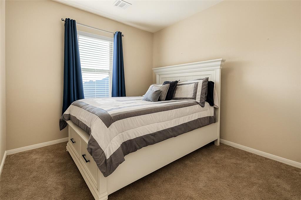 1837 Rialto Lane Crowley, TX 76036 - Photo 8 of 22 a bedroom with a bed and window