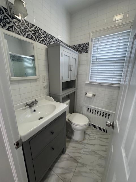 212 68th Street, Unit 1 Guttenberg, NJ 07093 - Photo 11 of 12 a bathroom with a toilet sink and mirror