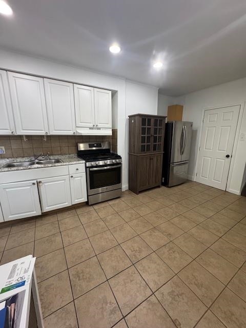 212 68th Street, Unit 1 Guttenberg, NJ 07093 - Photo 2 of 12 a kitchen with stainless steel appliances granite countertop a refrigerator sink and cabinets