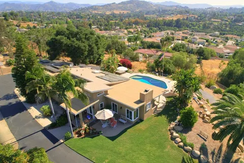 an aerial view of residential house with outdoor space and mountain view