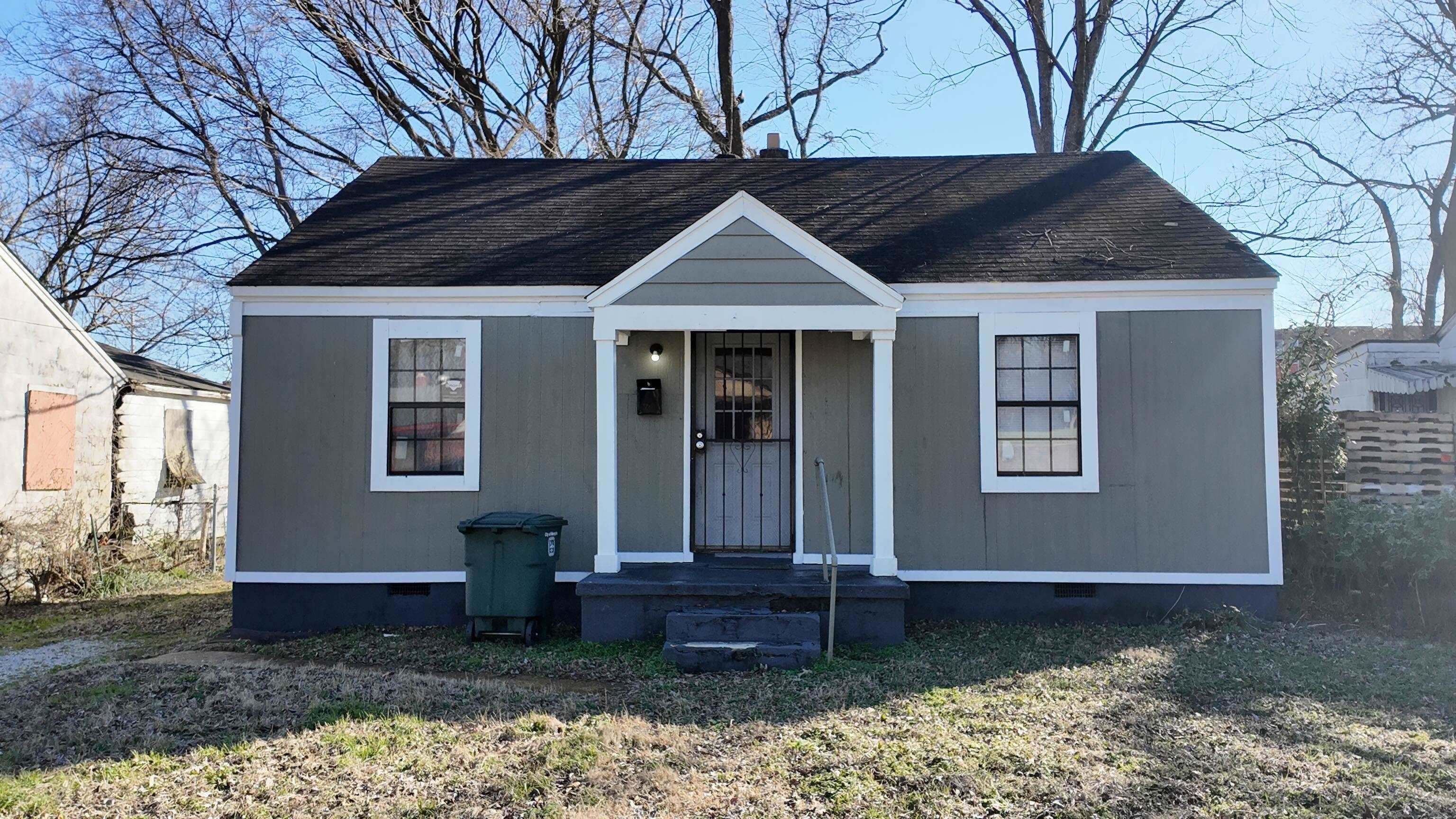 a house that has a tree in front of it