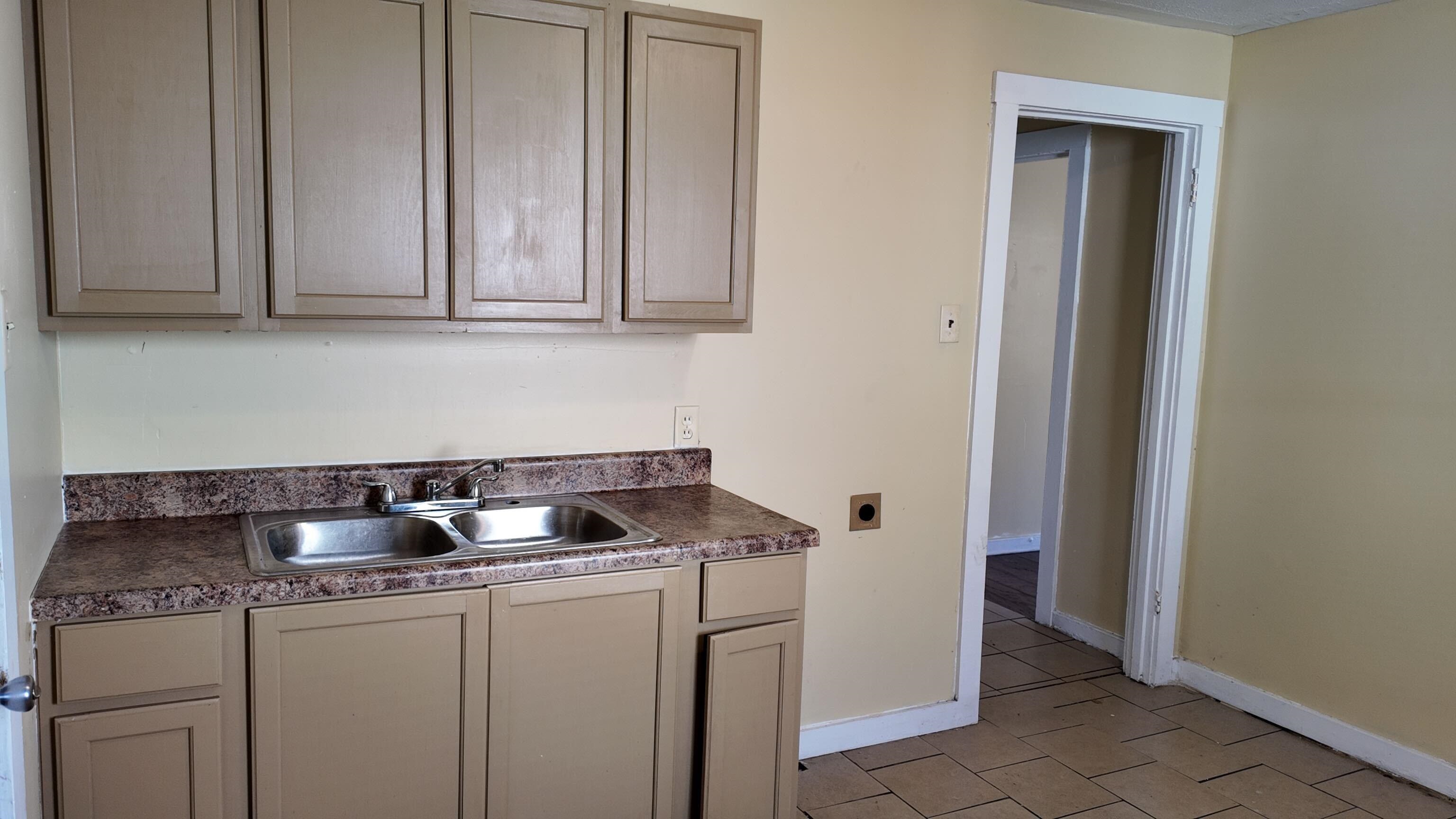 237 Modder Avenue Memphis, TN 38109 - Photo 17 of 19 a kitchen with granite countertop white cabinets and stainless steel appliances