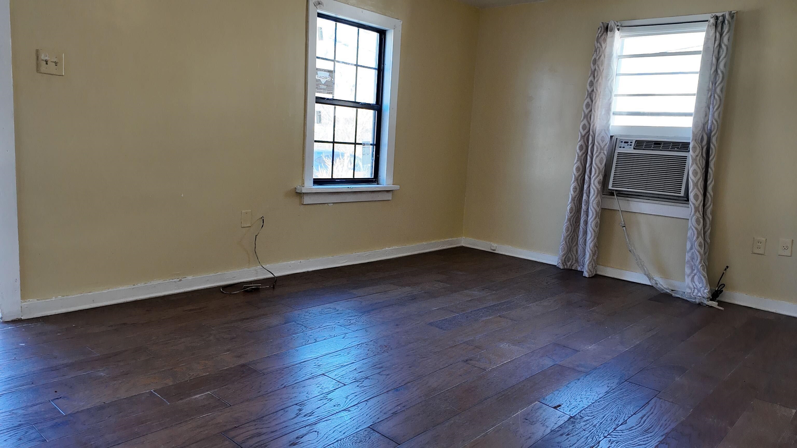 237 Modder Avenue Memphis, TN 38109 - Photo 10 of 19 an empty room with wooden floor closet and windows